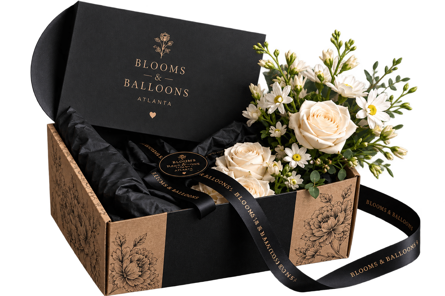 White roses and seasonal flowers in a signature black and gold gift box